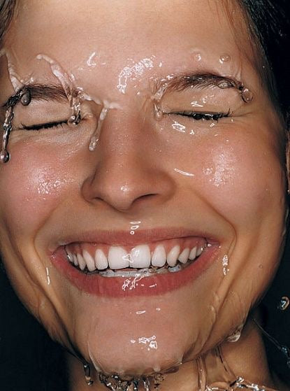 Smiling woman's face rinsed with water